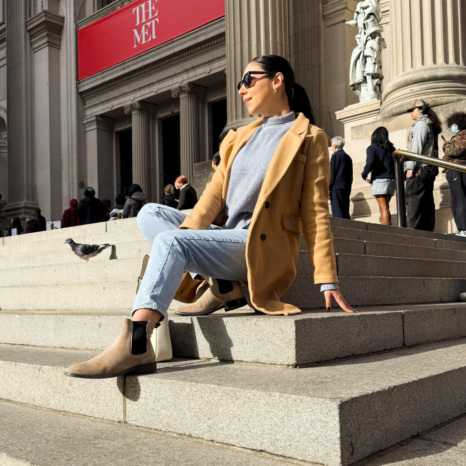 A woman wearing shadowed boots in the afternoon, exuding comfort and ease.